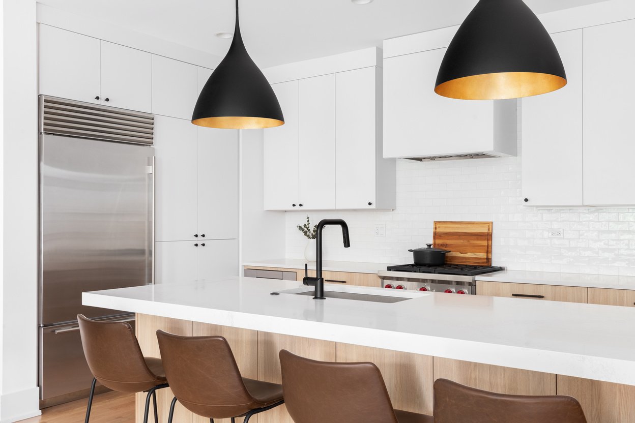 A kitchen detail with white and white oak cabinets.